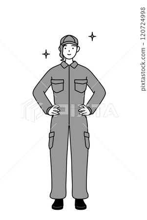 A female mechanic in overalls with her hands on her hips 120724998