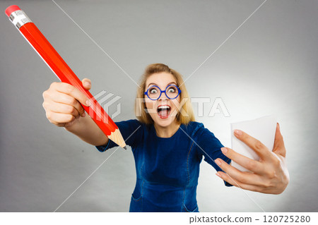 Crazy woman holds big pencil in hand 120725280