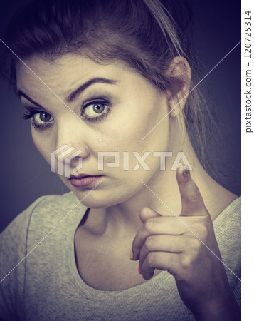 Woman wearing eyeglasses pointing at camera 120725314