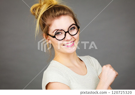 Happy teenage woman wearing eyeglasses 120725320