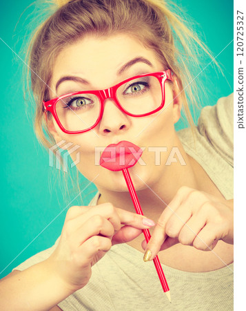 Happy woman holding fake lips on stick Happy woman holding fake lips on stick 120725327