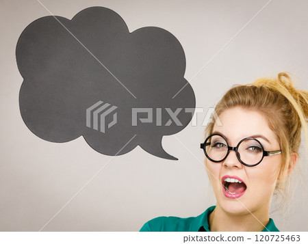 Woman holding black thinking bubble Woman holding black thinking bubble 120725463