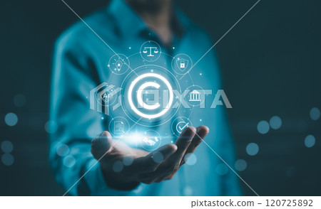 Digital copyright, patent concept. Businessman hold digital icons representing copyright, intellectual property, patents, legal protection, and safeguarding digital and intellectual assets. trademark, 120725892