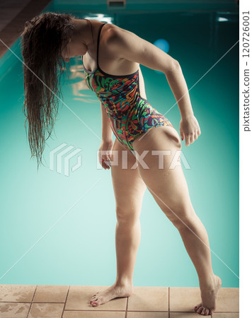 Woman in swimsuit stand at edge swimming pool. Woman in swimsuit stand at edge swimming pool. 120726001