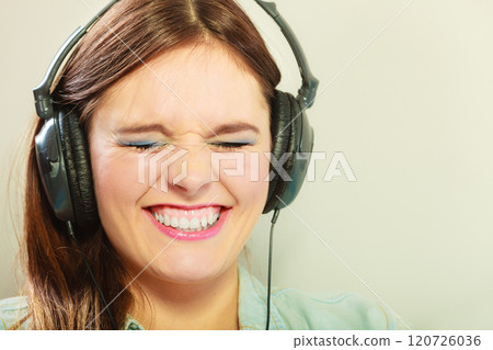 Woman with headphones listening music 120726036