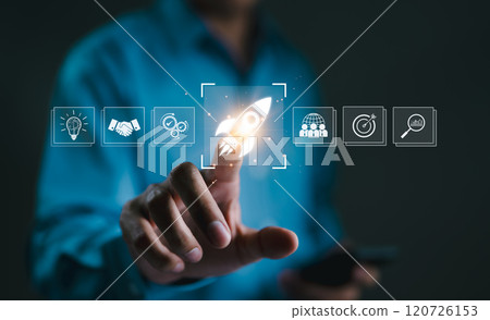 Business Growth and Startup Success Concept. A hand touching rocket icon on digital interface, symbolizing business growth, startup success, innovation, and achieving goals through strategic planning. 120726153