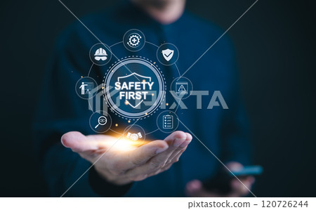 Safety first concept. Work safety compliance, A professional holds digital "Safety First" with icons that symbolize work safety, compliance, and protective measures. protection, workplace regulations, Safety first concept. Work safety compliance, A professional holds digital "Safety First" with icons that symbolize work safety, compliance, and protective measures. protection, workplace regulations, 120726244
