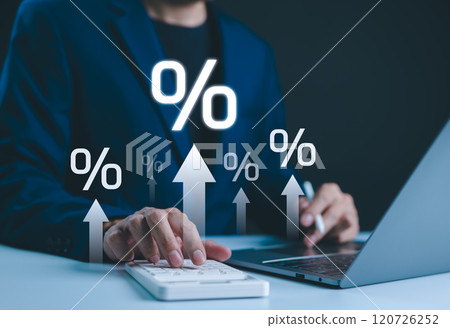 Interest rate increase concept. Businessman use a calculator and laptop with percentage symbols and upward arrows, symbolizing rising interest rates. financial growth, dividend yield, income, expenses 120726252