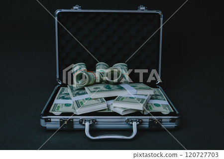 Open briefcase filled with cash banknotes. Open briefcase filled with cash banknotes. 120727703