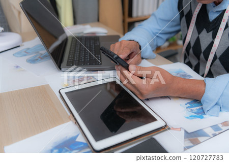 Professional using devices at a desk Professional using devices at a desk 120727783