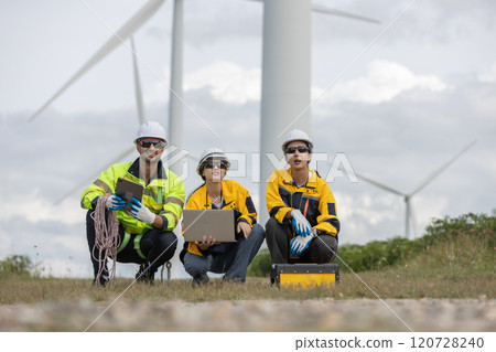 Engineer wearing safety uniform using laptop discussed plan about renewable energy at station energy power wind turbine. technology protect environment reduce global warming problems. Engineer wearing safety uniform using laptop discussed plan about renewable energy at station energy power wind turbine. technology protect environment reduce global warming problems. 120728240