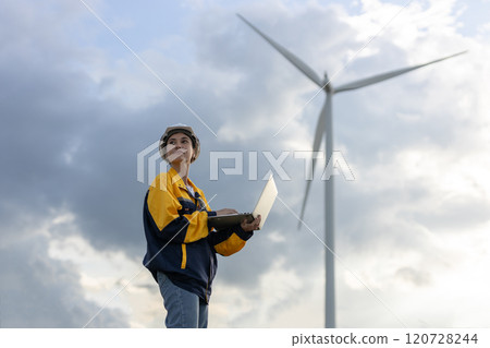 Renewable energy systems concept, engineer female using laptop working wind turbine for alternative energy, Technology protect environment reduce global warming problems. Renewable energy systems concept, engineer female using laptop working wind turbine for alternative energy, Technology protect environment reduce global warming problems. 120728244