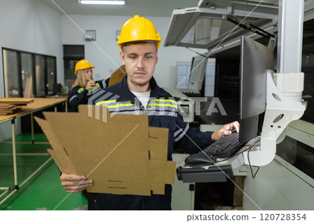 Man paper warehouse worker check quality and quantity cardboard corrugated carton in storage stock product with computer system . Large industry in paper production line. Man paper warehouse worker check quality and quantity cardboard corrugated carton in storage stock product with computer system . Large industry in paper production line. 120728354