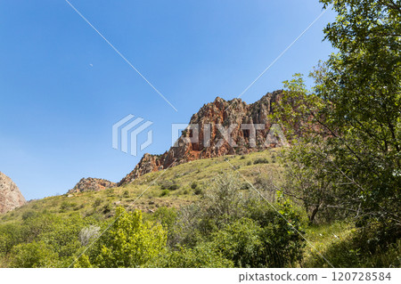 Exploring the stunning beauty of Noravank monastery surrounded by red mountains in Armenia 120728584