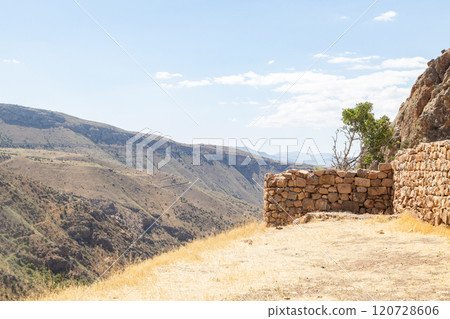 Majestic Noravank Monastery amidst the stunning red mountains of Armenia under a serene sky 120728606
