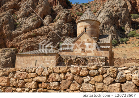 Majestic Noravank Monastery nestled among vibrant red mountains of Armenia at sunset Majestic Noravank Monastery nestled among vibrant red mountains of Armenia at sunset 120728607