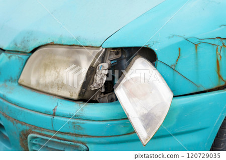 An old car with a disassembled front left headlight and a rusty fender. An old car with a disassembled front left headlight and a rusty fender. 120729035