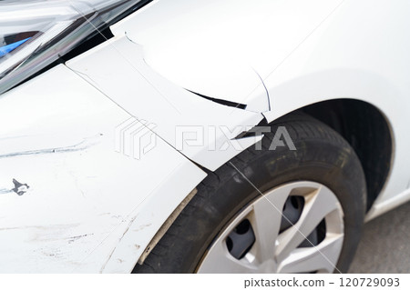 Damaged front left fender of a passenger car close-up. Damaged front left fender of a passenger car close-up. 120729093