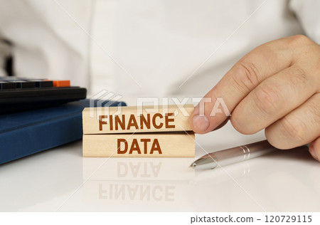 In the hands of a businessman, wooden blocks with the inscription - FINANCE DATA In the hands of a businessman, wooden blocks with the inscription - FINANCE DATA 120729115