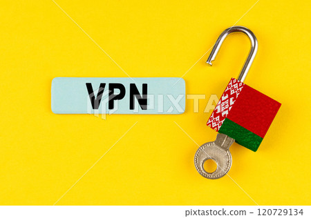 On the yellow surface is an open lock with a key and a sticker with the inscription - VPN On the yellow surface is an open lock with a key and a sticker with the inscription - VPN 120729134