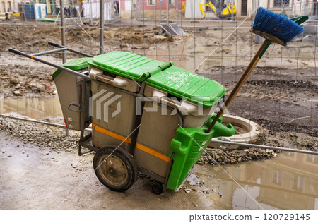 Green trolley container for street cleaning, stands near the construction site 120729145