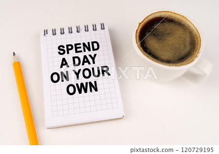 On a white surface, a cup of coffee, a pencil and a notepad with the inscription - Spend a day on your own 120729195