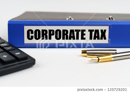 On a white surface, a calculator, a pen and a folder with the inscription - Corporate Tax On a white surface, a calculator, a pen and a folder with the inscription - Corporate Tax 120729201