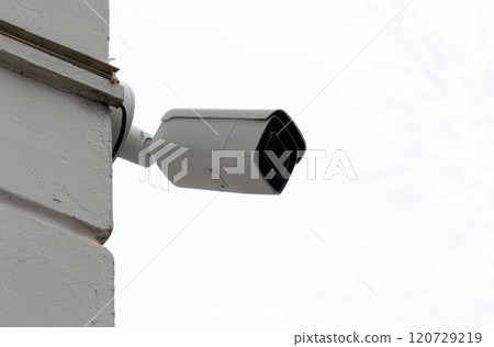 Surveillance camera mounted on the corner of the building. Surveillance camera mounted on the corner of the building. 120729219