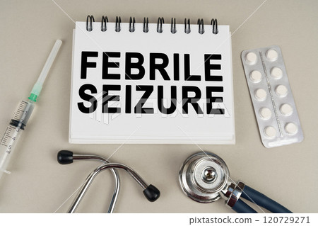 On a gray surface there is a syringe, a stethoscope and a notepad with the inscription - Febrile seizure On a gray surface there is a syringe, a stethoscope and a notepad with the inscription - Febrile seizure 120729271