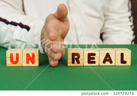 A man separates the cubes with the inscription - UN REAL 120729278