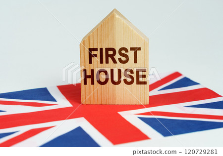 On the flag of Great Britain there is a model of a wooden house with the inscription - FIRST HOUSE On the flag of Great Britain there is a model of a wooden house with the inscription - FIRST HOUSE 120729281