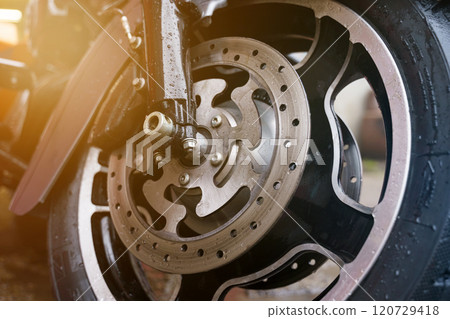 Wheel and disc brake system of a motorcycle close-up. Wheel and disc brake system of a motorcycle close-up. 120729418