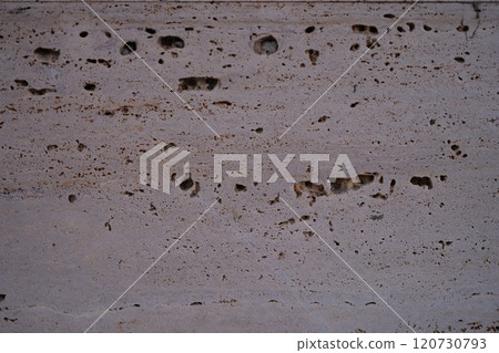 Textured Concrete Surface Featuring Distinct Pockmarks and Veins Throughout the Material Textured Concrete Surface Featuring Distinct Pockmarks and Veins Throughout the Material 120730793