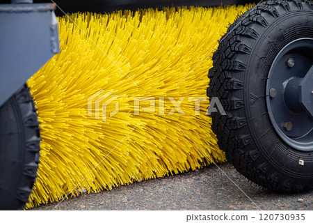 Close-up of industrial street sweeper brush and wheels. Close-up of industrial street sweeper brush and wheels. 120730935