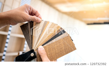 Designer hand picking sample of wood laminated material from natural collection Designer hand picking sample of wood laminated material from natural collection 120732392