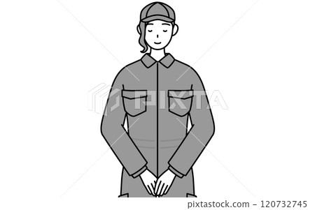 A female mechanic in overalls with her hands folded in front of her 120732745
