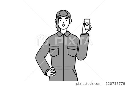 A female mechanic in overalls using a smartphone at work 120732776