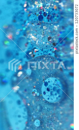 Sparkling oil. Acrylic paint spill. Defocused blue color shiny sequin particles gel fluid floating bubbles ink emulsion liquid drip abstract art background. Sparkling oil. Acrylic paint spill. Defocused blue color shiny sequin particles gel fluid floating bubbles ink emulsion liquid drip abstract art background. 120733072