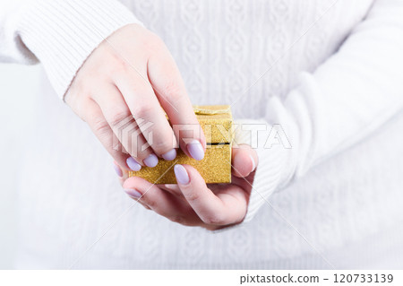 Female hands open a yellow gift box. Female hands open a yellow gift box. 120733139