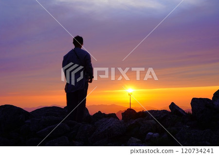 Climbers watching the sunset from the summit of Mount Ito in the Asahi Mountain Range 120734241