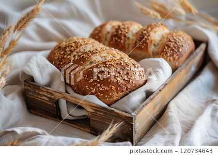 Freshly baked bread with sesame seeds in a wooden box. 120734643