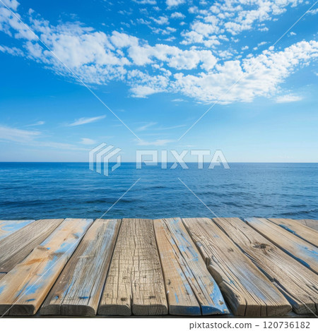 Weathered Wooden Planks Overlooking a Tranquil Blue Ocean 120736182