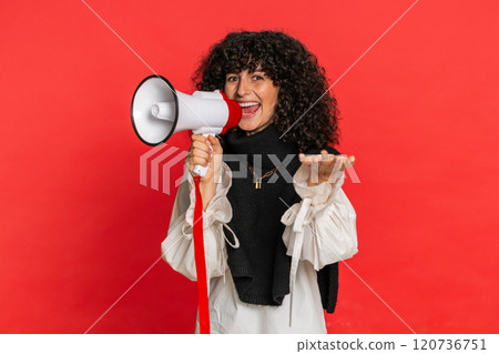 Young woman talking with megaphone, proclaiming news, loudly announcing advertisement discounts sale 120736751