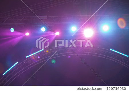 Purple stage background with multicolored rays of light from spotlights. 120736980