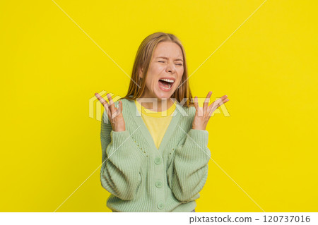 Irritated angry young woman screams from stress tension problem feels horror hopelessness shock rage 120737016