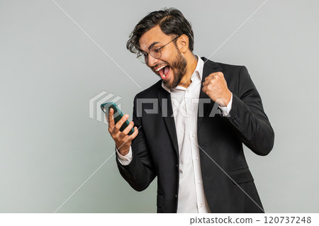 Happy excited winner man use smartphone celebrating success, winning play game, good lottery news Happy excited winner man use smartphone celebrating success, winning play game, good lottery news 120737248