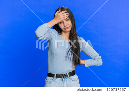 Young woman making face palm gesture, feeling bored, disappointed in result, bad news, sorrowful 120737267