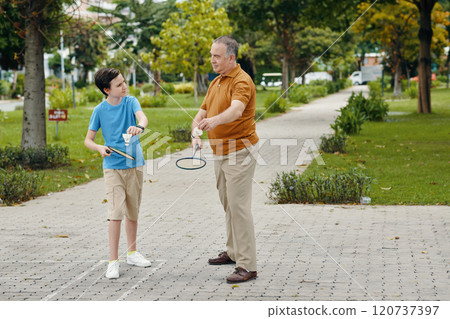 Boy Playing Badminton With His Grandfather 120737397