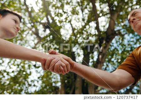 Grandfather Greeting His Grandson Outdoors 120737417