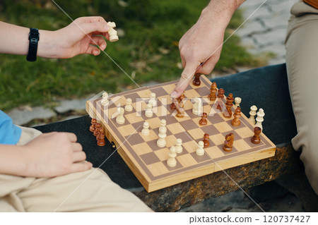 Family Playing Chess Together Outdoors Family Playing Chess Together Outdoors 120737427